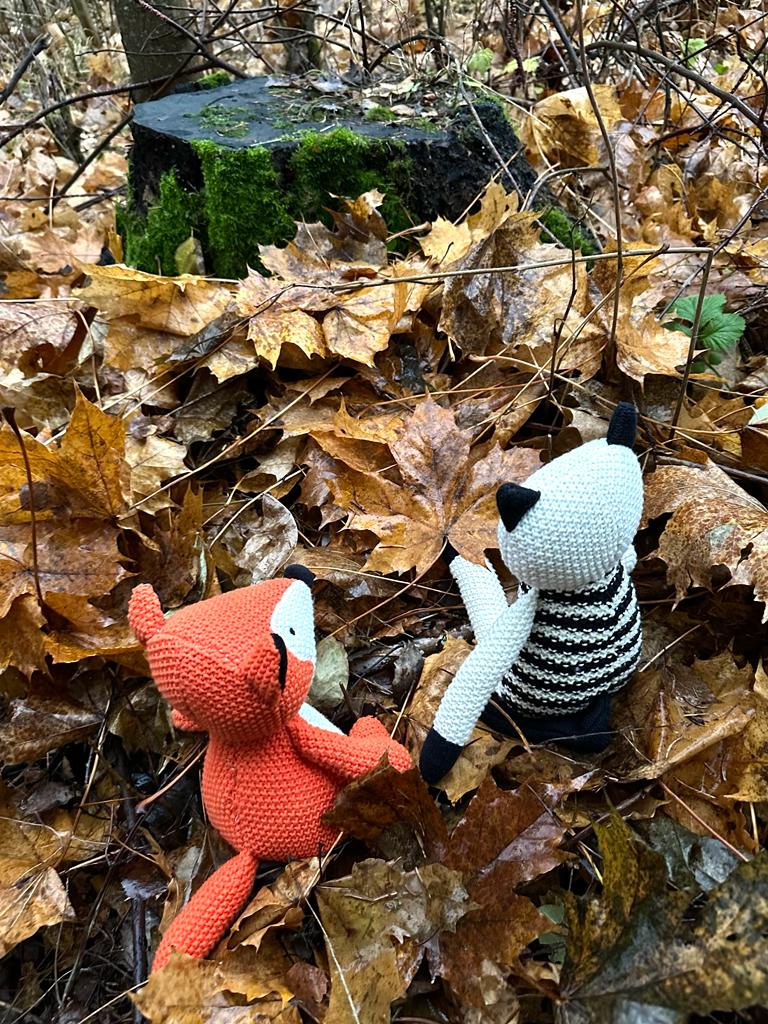 Eeri ja Nemo istuvat metsässä, ison lehtikasan vieressä.